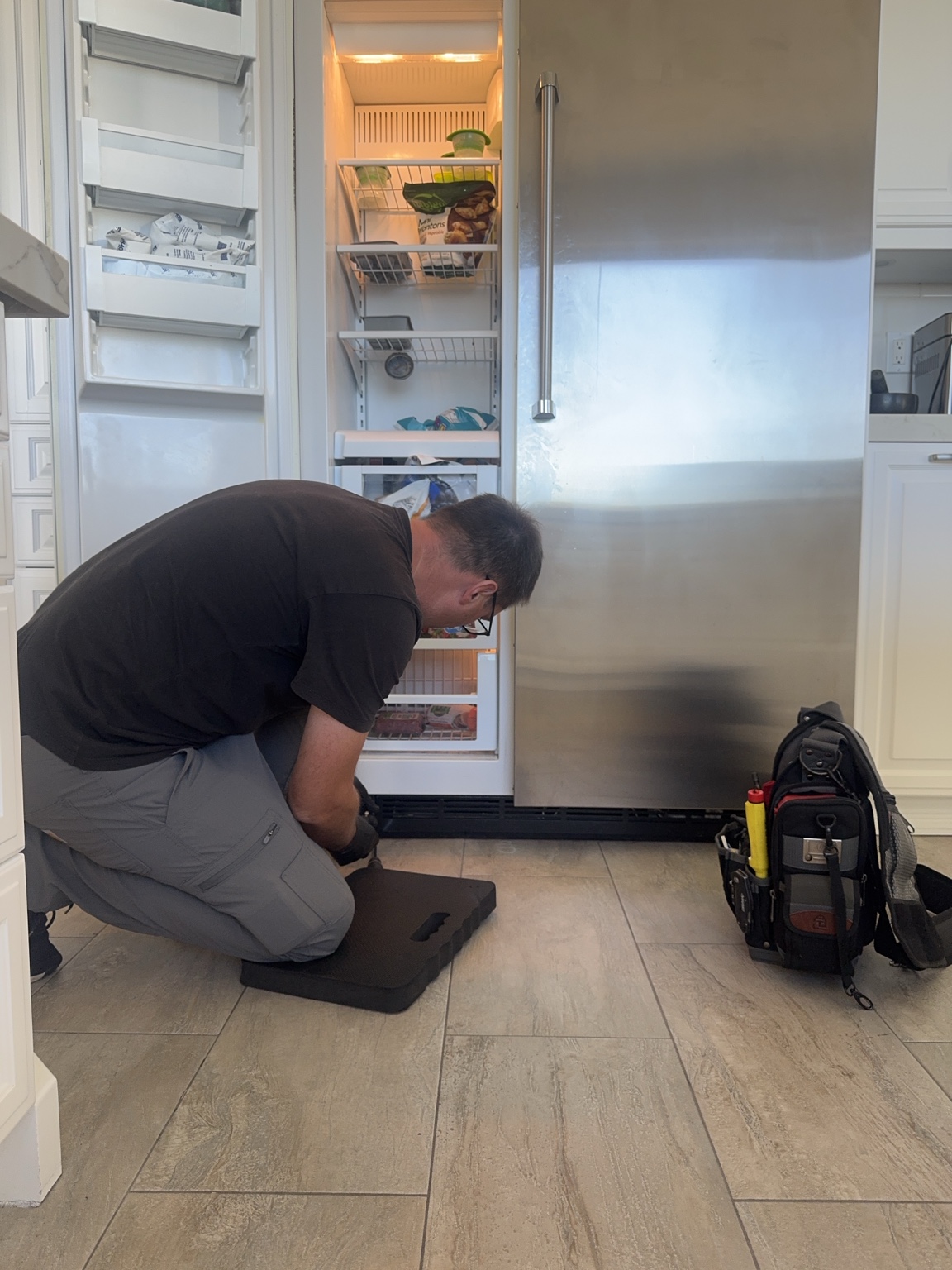 Anton working on a refrigerator